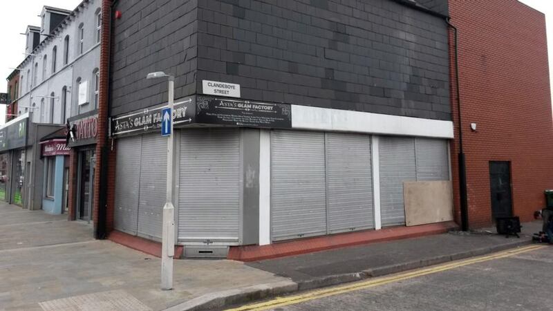 Shutters shield the damage to a beauty salon owned by a Polish woman that was set on fire in the latest of a spate of attacks on foreign nationals in Belfast. Photograph: PA