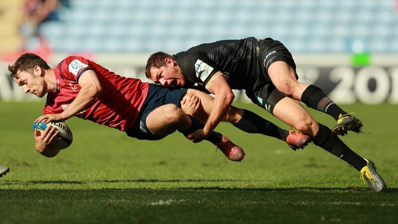 Darren Sweetnam of Munster is tackled by Alex Goode. Photograph: David Rogers/Getty Images