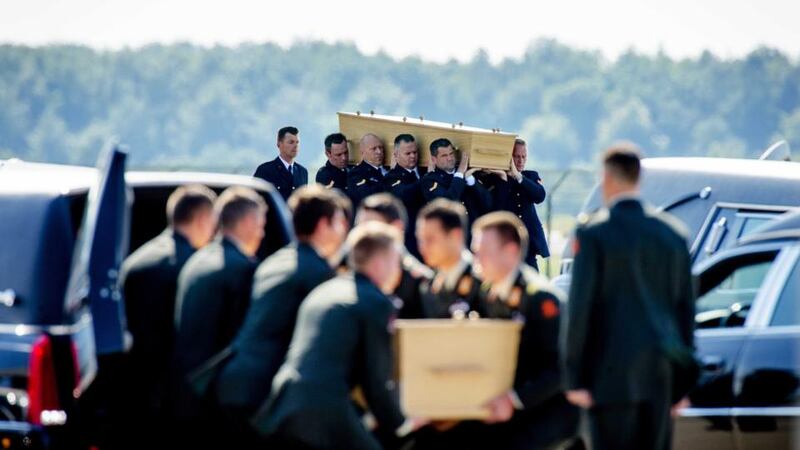 Dutch military personnel carry coffins containing victims of the MH17 plane crash at the airbase in Eindhoven. Photograph: Robin Van Lonnkhuijsen/EPA