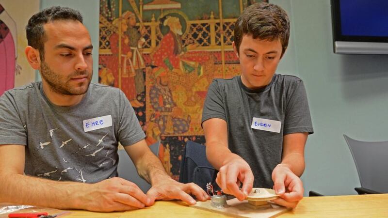 Electronics engineer Emre Uzun (left) and Evern Sarisoy from Booterstown, Co Dublin, at the robot workshop for teenagers in the Chester Beatty Library, Dublin, that formed part of National Heritage Week. Photograph: Dara Mac Dónaill