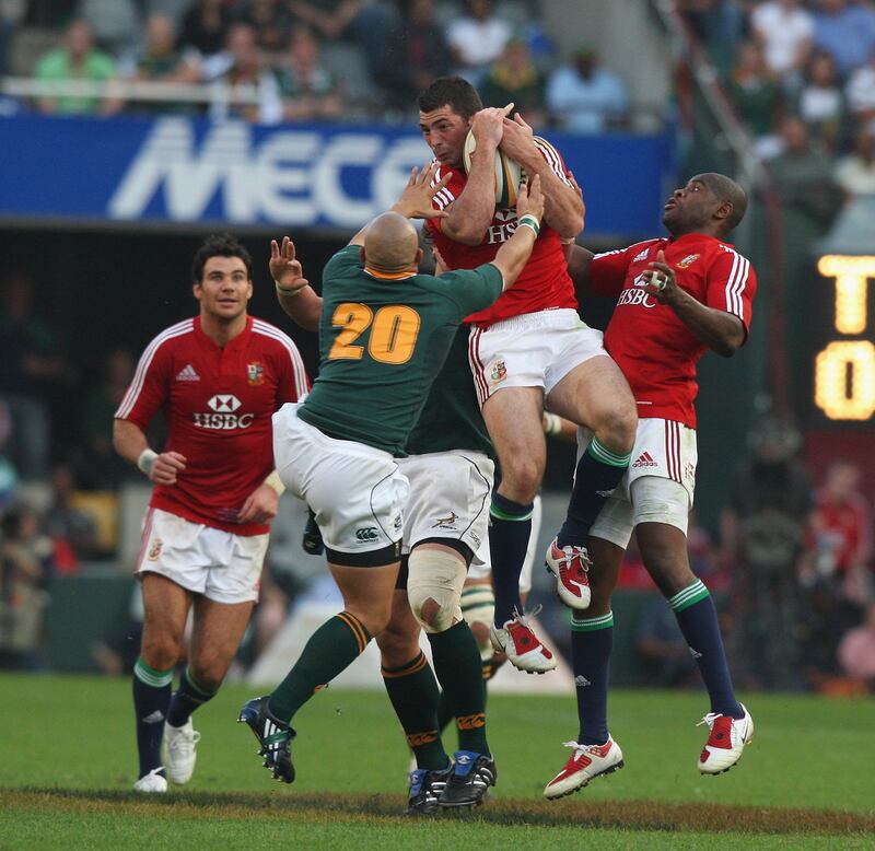 Rob Kearney, of the Lions catches the ball as Ricky Januarie challenges. Photograph: David Rogers/Getty