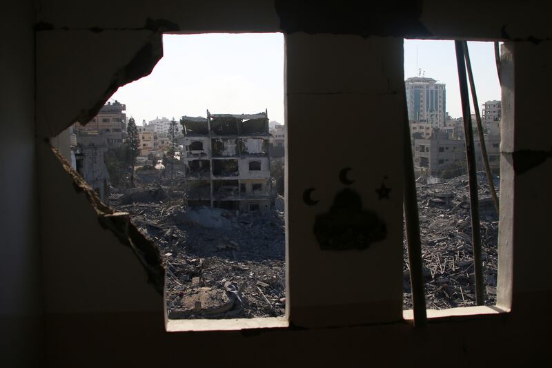 Palestinian citizens inspect damage caused by Israeli airstrikes. Photograph: Ahmad Hasaballah/Getty Images