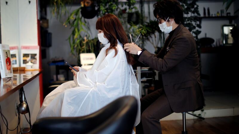 Akihiro Yoshida, the owner of Hair salon Pinch, gives hair treatment to his customer Natsuki Suda, in Tokyo, Japan,on Tuesday. Photograph: Kim Kyung-Hoon/Reuters