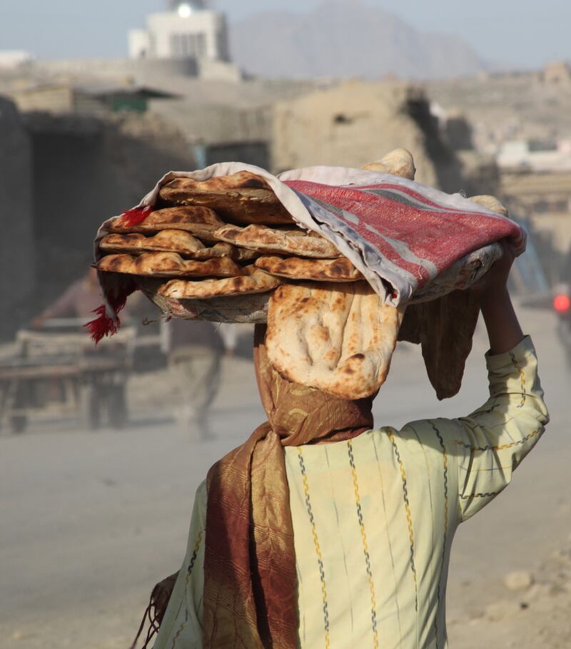 An Afghan women sells fresh bread at the market in Kabul, Afghanistan. Photograph: Brenda Fitzsimons