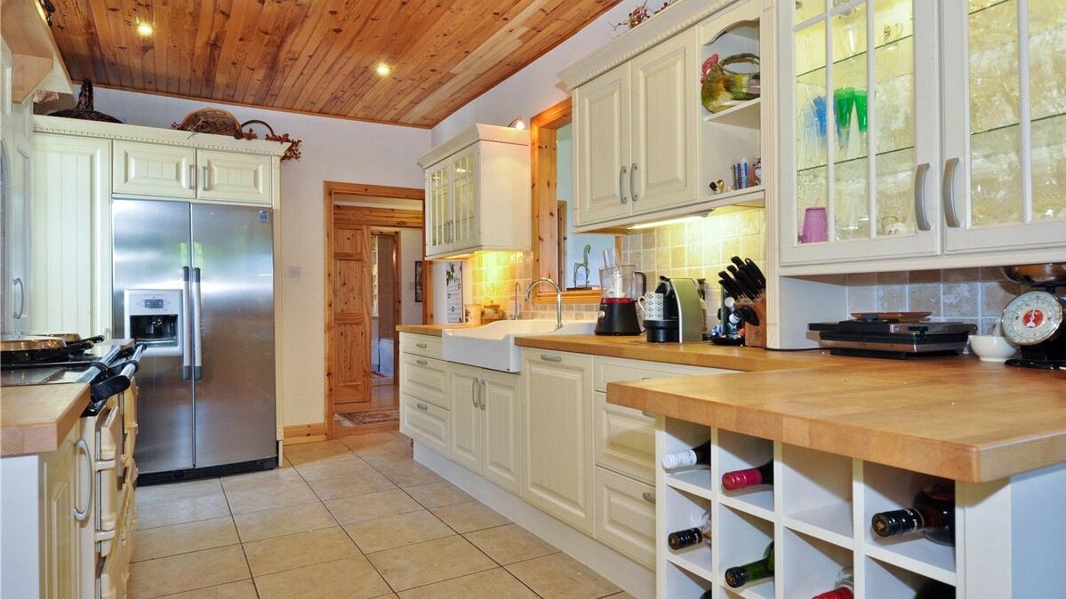 The kitchen has German-engineered cabinets with granite countertops and an electric four-door Aga