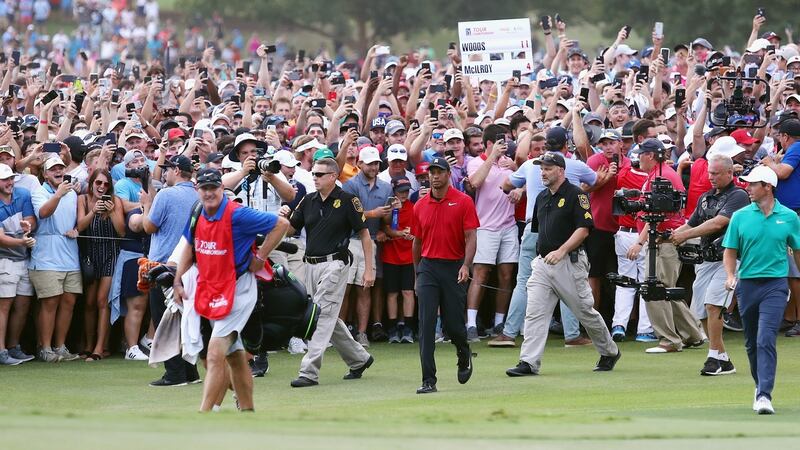 Fans flock to follow Tiger Woods down the 18th at East Lake. Photograph: Tim Bradbury/Getty