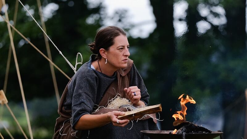 A woman lights a fire outside her tent as the lives of Roman Legionnaires are re-enacted during the Hadrian’s Wall Live in Carlisle, England. File photograph: Ian Forsyth/Getty Images