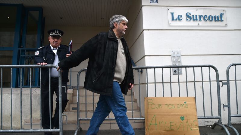 A placard reads ‘For our friends from Angers’ as the departmental director of public safety Francis Wetta (L) and Chief Superintendent of the Regional Judicial Police Service Lucien Arleri leave a building in which four people were killed and several others injured after a balcony collapsed, on Saturday night in Angers, western France. Photograph: Jean-Francois Monier/AFP/Getty Images