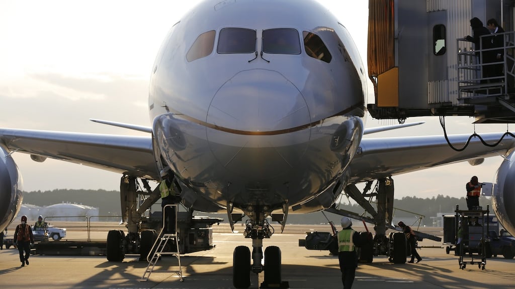 Ground staff work under an United Airlines’ Boeing 787 Dreamliner plane in Tokyo.