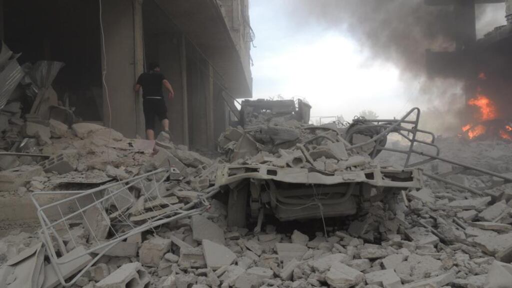 A man walks on rubble as he inspects the damage after what activists said was shelling by forces loyal to Syria’s president Bashar al-Assad in Arbaeen, near Damascus. Photograph: Diaa Al-Din/Shaam News Network/Reuters