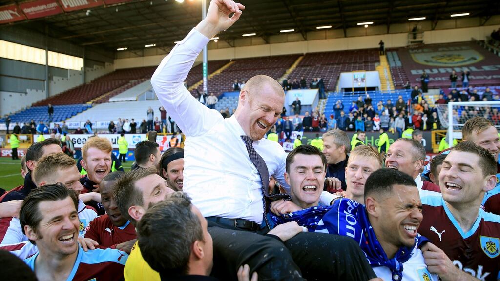 Burnley manager Sean Dyche is hoisted up by the players as they celebrate promotion after beating Derby County. Photo: Tim Goode/PA