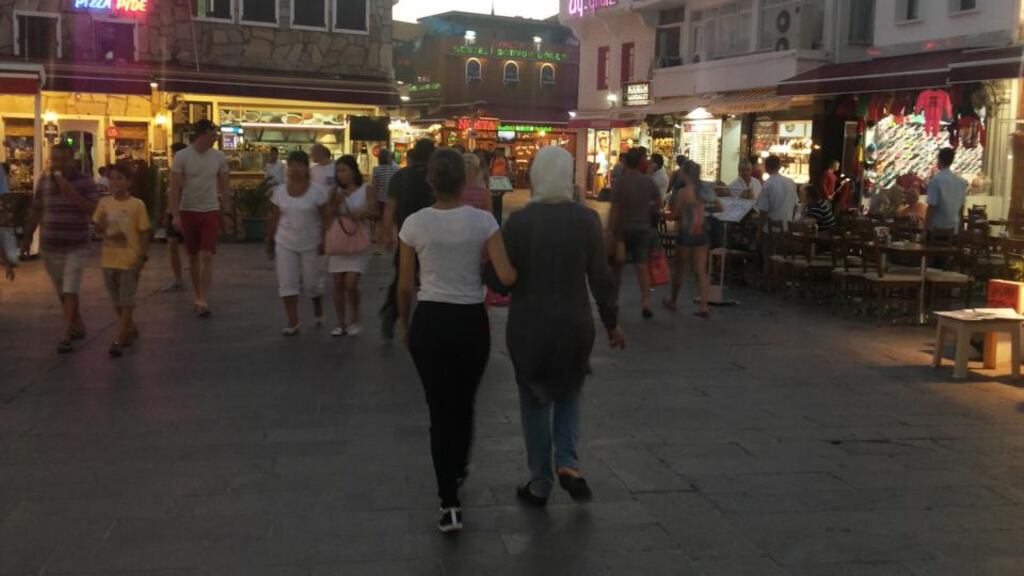 Jamil’s mother Leila, and sister Carla, walking in a square in Greece en route to Germany in 2014.