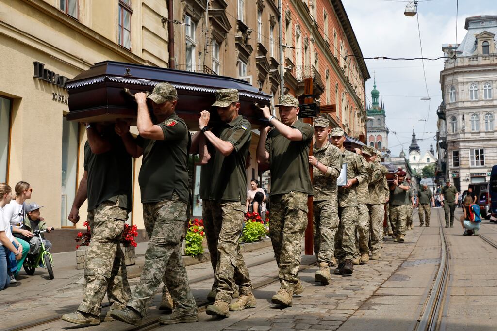 Ukrainian servicemen carry coffins during a farewell ceremony in Lviv, Ukraine, for 12 soldiers who died in Russian captivity. Photograph: EPA