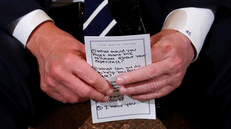 US president Donald Trump holds a list of prepared questions as he hosts a listening session with high school students and teachers to discuss school safety at the White House in Washington. Photograph: Jonathan Ernst/Reuters