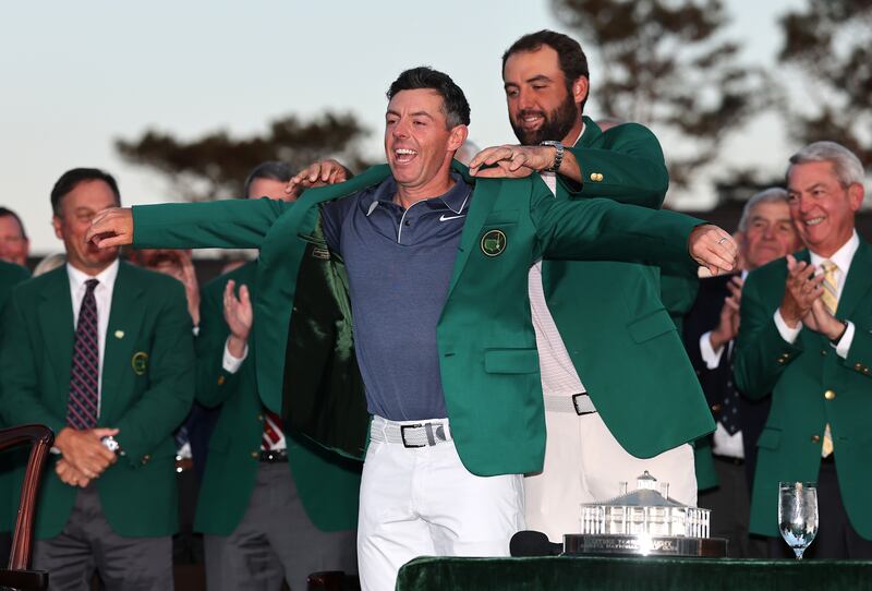 McIlroy is awarded his Masters green jacket by Scottie Scheffler. Photograph: Michael Reaves/Getty