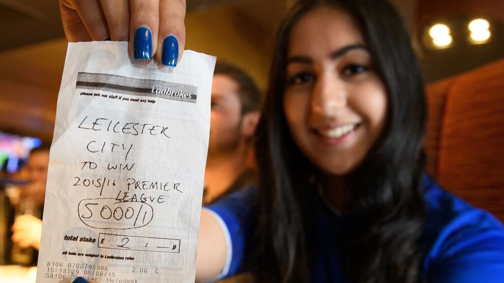 Student Karishma Kapoor holds her betting slip with odds of 5000/1 if Leicester City win the Premiership title. Photograph: Getty Images