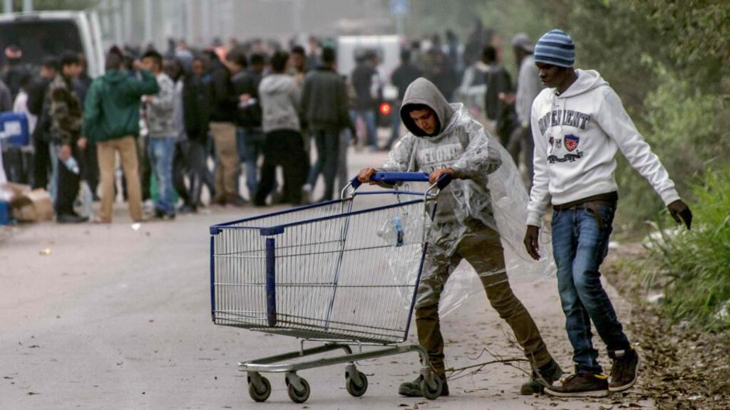Migrants at the site of the Calais “Jungle” camp. Fifteen hundred unaccompanied minors are living temporarily in containers in the French port town. Photograph: Philippe Huguen/AFP/Getty Images