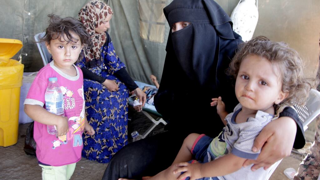 Displaced Syrians at a Jordanian military medical outpost, near Nasib border crossing between Jordan and Syria. Photograph: Ahmad Abdo/EPA