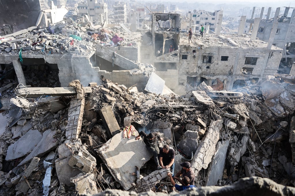 Palestinians try to recover a body from the rubble of a house destroyed in an overnight Israeli strike, in Gaza City, on October 29th. Photograph: Omar Al-Qattaa/AFP via Getty