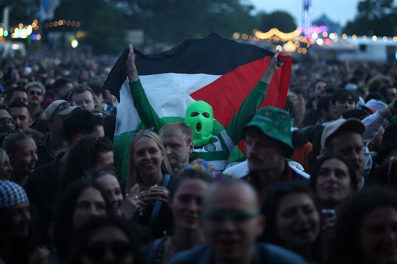 Kneecap: Festivalgoers hold Palestine flags as they wait to hear the Belfast rap trio perform at Wide Awake Festival in London. Photograph: Henry Nicholls/AFP/Getty Images