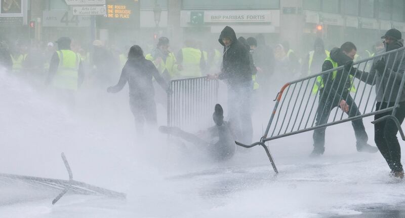 Police use water cannons to disperse protesters in central Brussels Photograph: Olivier Hoslet/EPA
