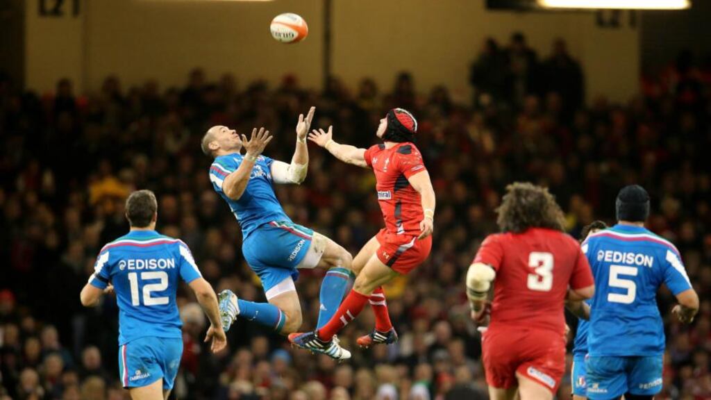Wales’ Leigh Halfpenny and Sergio Parisse of Italy challenge for the high ball at the Millennium Stadium. Photograph: Cathal Noonan/Inpho