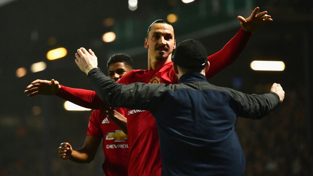 Zlatan Ibrahmiovic celebrates with one of 7,000 travelling Manchester United fans after his late winner at Blackburn. Photograph: Dan Mullan/Getty
