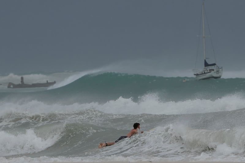 A surfer braves the waves in Carlisle Bay as Hurricane Beryl passes through Bridgetown, Barbados. Photograph: Ricardo Mazalan/AP