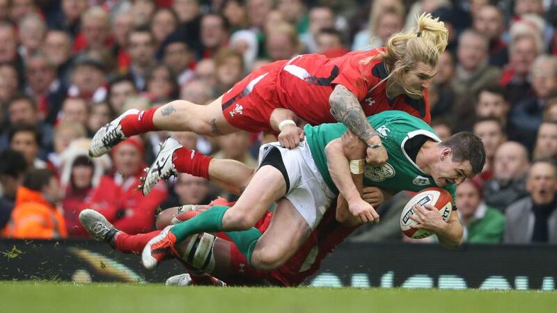 Ireland’s Jonathan Sexton is stopped in his tracks tackled by Richard Hibbard of Wales. Photograph: Dan Sheridan/Inpho