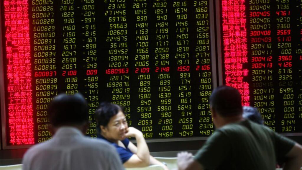 Chinese investors in front of a screen showing stock market movements. Chinese investors have 112 million accounts on the Shanghai stock market. Photograph: EPA/How Hwee Young