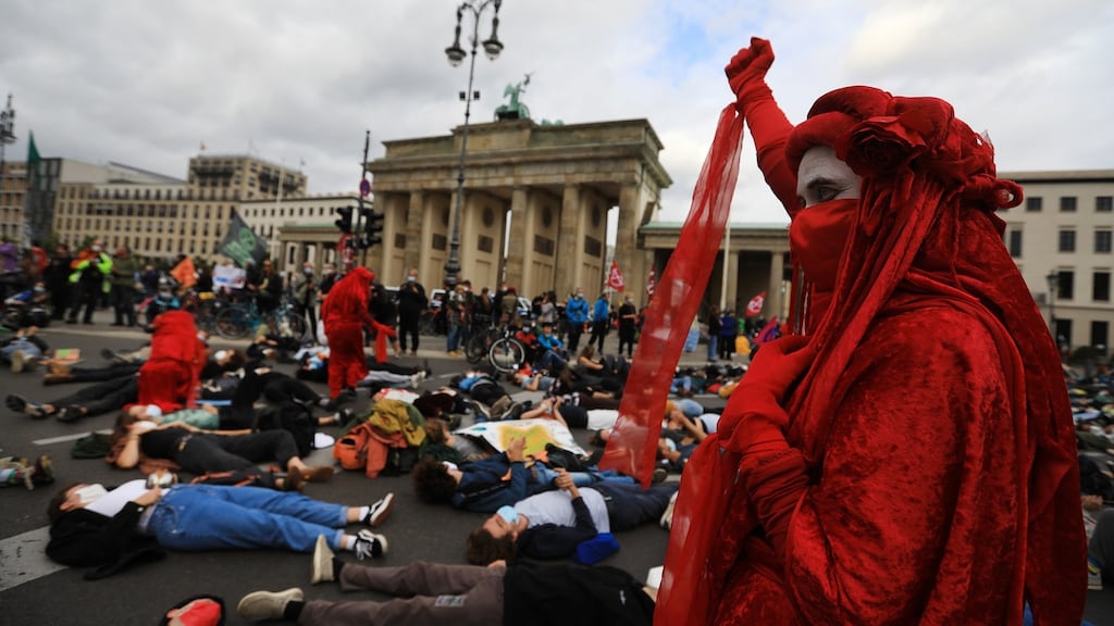 Extinction Rebellion’s Red Brigade protest at Brandenburg Gate in Berlin, on Tuesday. Photograph: Krisztian Bocsi/Bloomberg