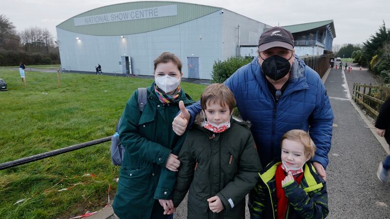 Denisa and Rad Dolzal bringing their children Piri (8) and Teemu (5) from Killester for their vaccination against Covid-19 at the Show Centre, Cloghran in Swords. Photograph: Alan Betson