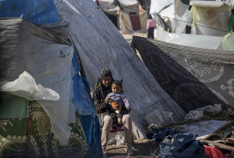 Two Palestinian children, who fled with their families from the northern Gaza Strip, sit outside their shelter in Deir Al Balah, Gaza Strip. Photograph: Mohammed Saber/EPA-EFE