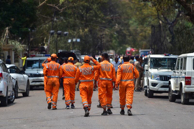 Officials move towards the site of crashed Air India Boeing 787. Photograph: Ritesh Shukla/Getty Images
