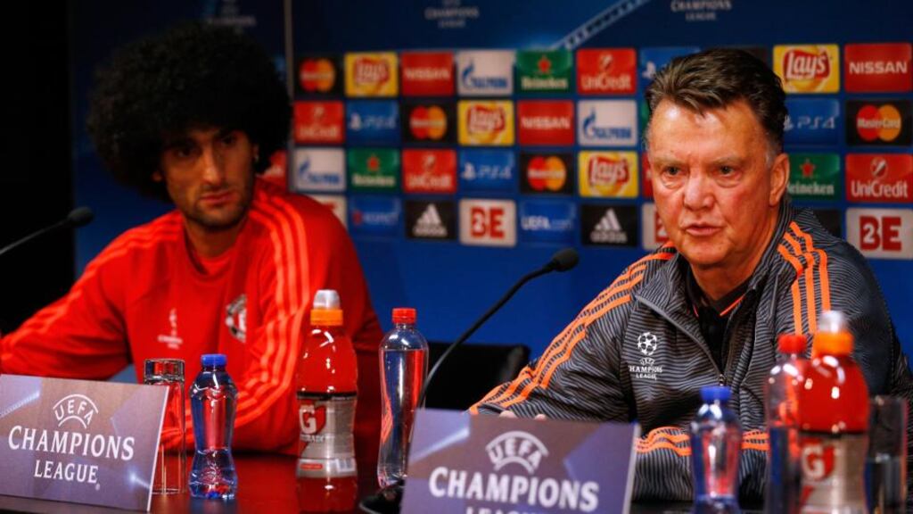Marouane Fellaini and Manchester United manager Louis van Gaal speak during the press conference held at Jan Breydel Stadium in Brugge. Photograph: Dean Mouhtaropoulos/Getty Images
