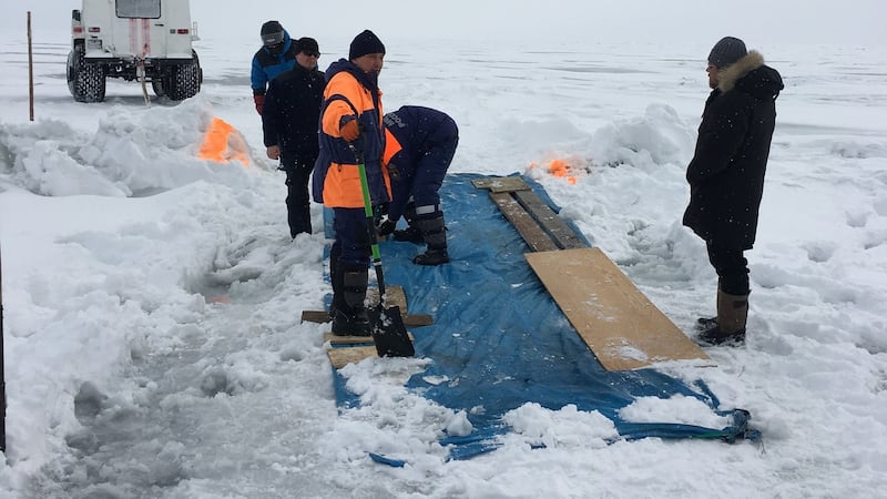 Alex (right) supervises construction of the makeshift crossing of the crack in the ice