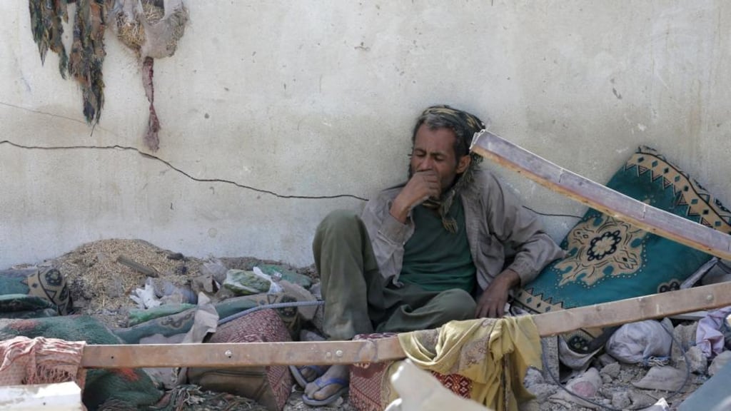A vendor rests upon the rubble of his shop destroyed by a Saudi-led air strike that hit a marketplace in Yemen’s capital, Sana’a, yesterday. Photograph: Khaled Abdullah/Reuters