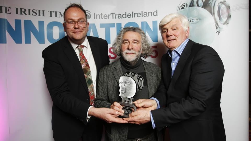 Timothy Brundle from Ulster University presenting the Creative Industries category award to winners Kevin Godley and Gerry Jones from WholeWorldBand. Photograph: Conor McCabe Photography