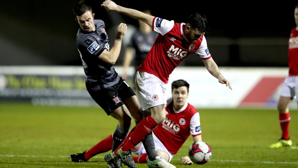St Pats’ Ryan Brennan and Robbie Benson of Dundalk fight for the ball. Photograph: Ryan Byrne/Inpho