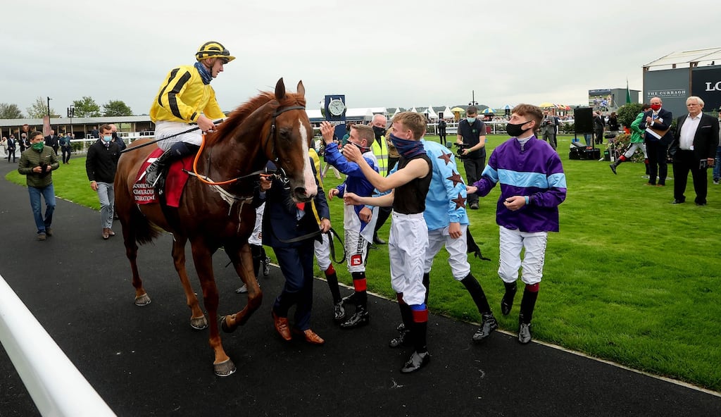 Ben Coen is congratulated in the parade ring by his fellow jockeys after winning the Comer Group International Irish St Leger at the Curragh. Photograph: Ryan Byrne/Inpho