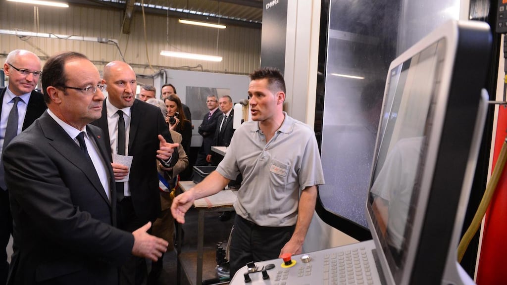 France's president Francois Hollande (left) shakes hands with an employee while visiting a precision tool factory in Blois earlier this month. Photograph: Reuters