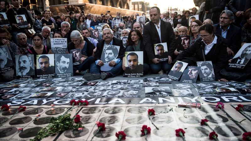 People hold portraits of Armenian intellectuals, who were detained and deported in 1915, during a rally in Istanbul in April to commemorate the 103rd anniversary of the 1915 mass killing of Armenians in the Ottoman Empire