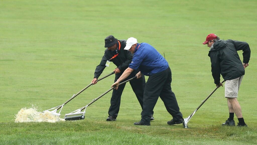 Grounds crew workers remove water from the second fairway during a weather delay on the first round of the 2013 U.S. Open golf championship at the Merion Golf Club in Ardmore, Pennsylvania. Photograph: Reuter/Adam Hunger