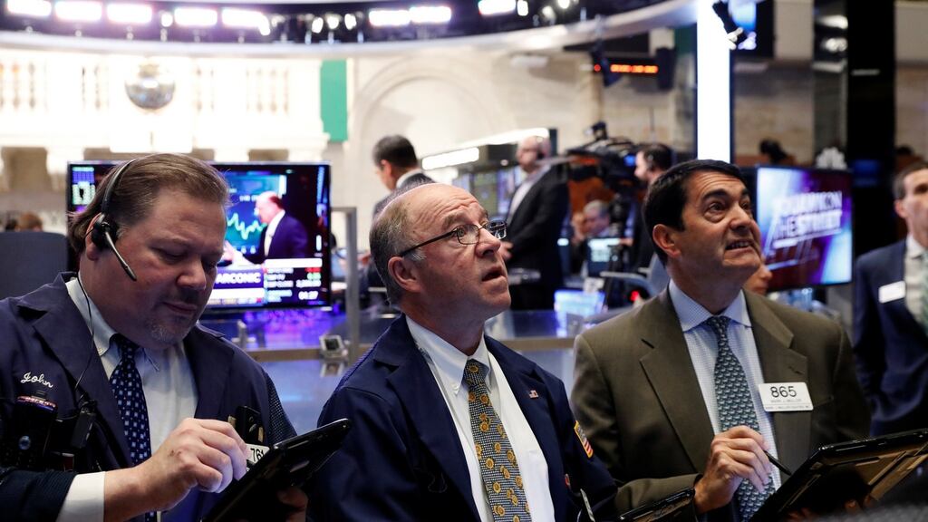 Wall Street traders: US stocks were up slightly on Thursday as a rise in consumer shares helped offset losses in financials
