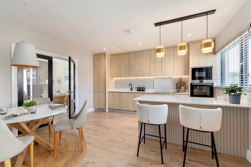 The kitchens come with full-height fitted units and stone worktops by FitzGerald Kitchens