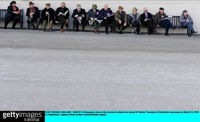 Racegoers relax on the benches to study form during racing at Cheltenham yesterday. Photograph: Alan Crowhurst/Getty Images