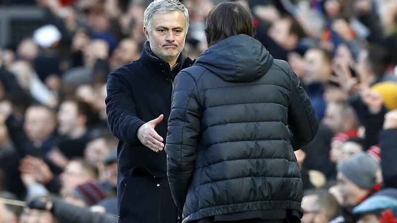 Antonio Conte and Jose Mourinho shake hands after the game. Photo: Martin Rickett/PA Wire