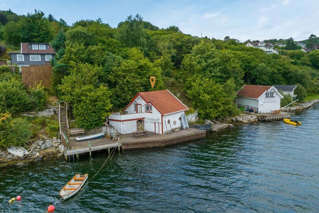 Norway: A wooden boathouse at the water’s edge in Rogaland.
