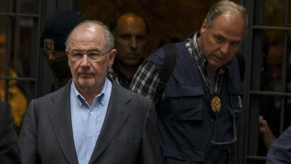 Rodrigo Rato (left), former People’s Party minister and former managing director of the International Monetary Fund, is lead by police as they leave his residence after an inspection in Madrid. Photograph: Sergio Perez/Reuters