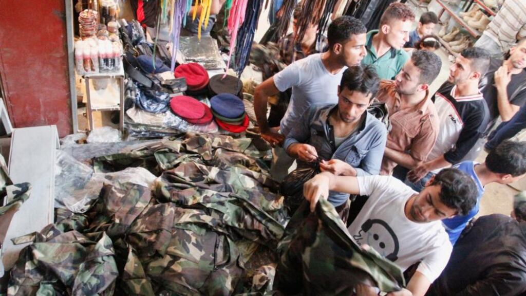 Iraqi men buy military uniforms yesterday at a shop in Basra, southeast of Baghdad. Photograph: Reuters/Essam Al-Sudani